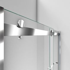 an image of a modern bathroom setting with glass and stainless steel fixtures on the wall