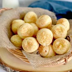 a basket filled with small donuts sitting on top of a table