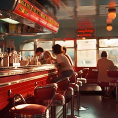 people sitting at the bar in a diner with red walls and stools, while one woman is leaning on the counter