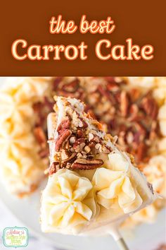 the best carrot cake is on a white plate with pecans and nuts around it