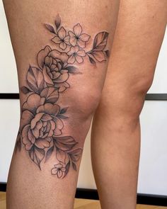 a woman's leg with flowers on it