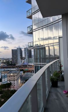 a balcony overlooking the city skyline at dusk