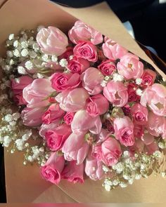 a bouquet of pink roses and baby's breath