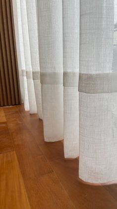 white curtains are lined up on the floor