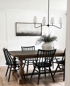 a dining room table with four chairs around it