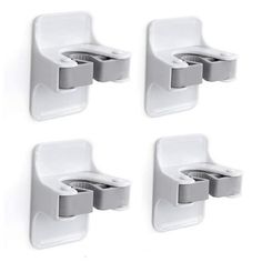 four white wall mounted toilet paper holders