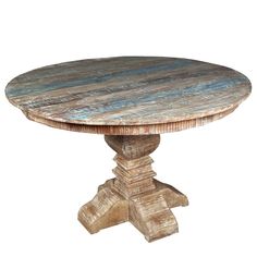 a round wooden table sitting on top of a white floor