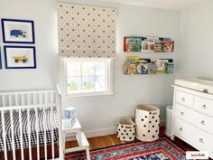 a baby's room with a crib, dresser, and window in it