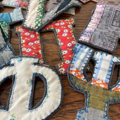 several pieces of fabric with the letters d and o on them sitting next to each other