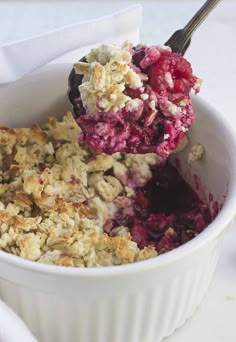 a scoop of ice cream with berries in it and some crumbs on top