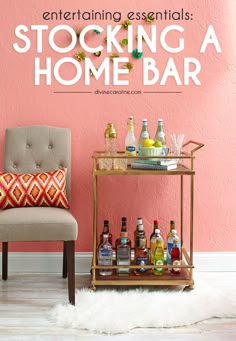 a bar cart with liquor bottles and drinks on it next to a chair in front of a pink wall