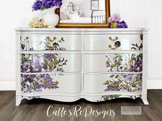 a white dresser with flowers painted on it