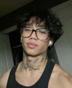 a woman with glasses and tattoos on her neck