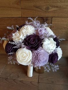 a bridal bouquet with purple and white flowers