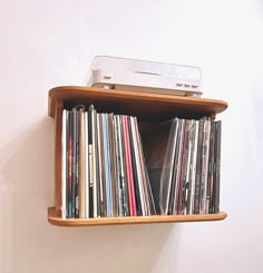 there is a shelf with many cds on it and an old stereo in the middle