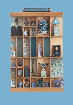 a wooden box filled with assorted items on top of a blue background and an image of a man