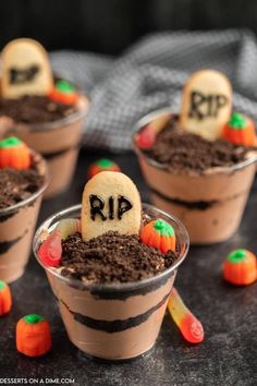 halloween desserts in plastic cups decorated with candy and candies