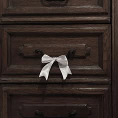 a drawer with a white bow on it