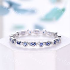 a white gold ring with blue sapphire stones