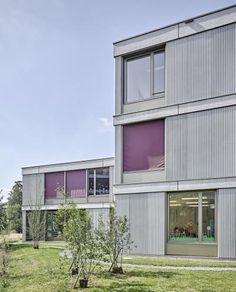 two buildings with windows and grass on the ground