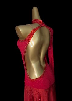 a woman's red leotard dress with sequins on the back