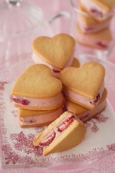 heart shaped sandwiches on a plate with one cut in half