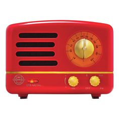 an old fashioned radio is red with gold trimmings and buttons on the front