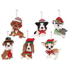 christmas ornaments with dogs wearing hats and scarves hanging from strings on a white background