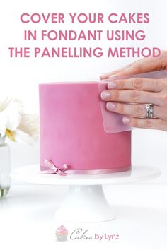 a woman is decorating a pink cake with flowers in the background and text overlay reads cover your cakes in fondant using the panelining method