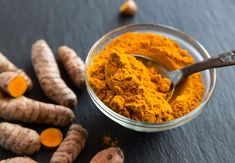 tumerical and ginger powder in a glass bowl with spoon