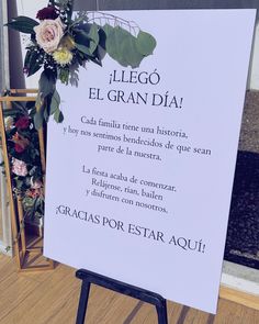 a sign with flowers on it in front of a door that says el grandia