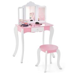 a pink and white vanity with mirror and stool on the top shelf next to it