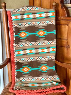 a blanket sitting on top of a wooden chair