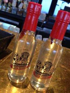 two empty bottles sitting on top of a counter