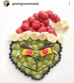 an image of a face made out of grapes and strawberries on top of each other