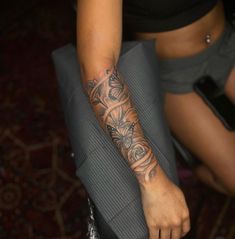 a woman with a tattoo on her arm holding a piece of luggage in her hand