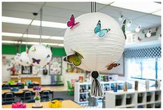 some paper lanterns hanging from the ceiling in a classroom