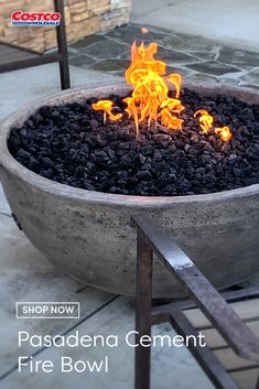 the fire bowl is made from concrete and has flames coming out of it, as well as coal