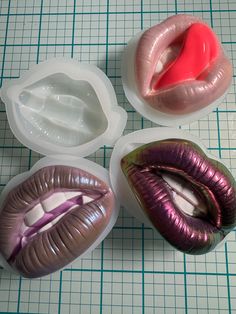 four different types of fake lips in plastic containers