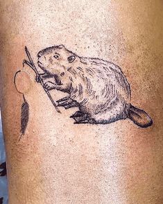 a tattoo on the leg of a person with a rodent holding a fishing rod