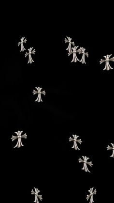 many small white crosses on a black background