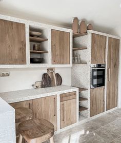 a kitchen with wooden cabinets and white counter tops