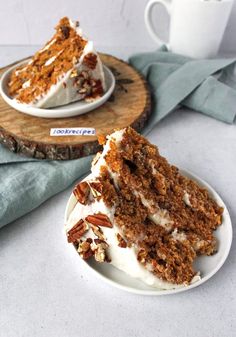 two slices of carrot cake with white frosting and pecans