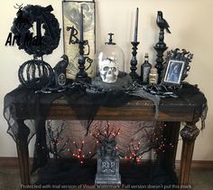 a mantle with candles and decorations on it in front of a wall that says, halloween