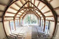 the inside of a church with rows of pews in front of large windows and doors