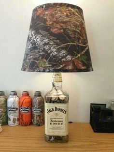 a lamp that is sitting on top of a table next to some bottles and cans