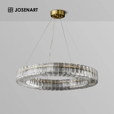 a chandelier hanging from the ceiling with clear glass and gold trimmings