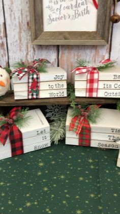 Display a festive stack of bookswith a popular Christmas saying on your coffee table. Christmas Bazaar Table Display, 2x4 Xmas Projects, Wood Christmas Packages, Wooden Christmas Boxes, Christmas Stacked Books Diy, Popular Christmas Decor 2022, Christmas Wood Book Stacks, Christmas Stacked Books, Christmas Book Stacks Diy