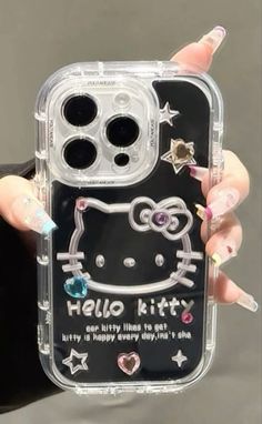 a hello kitty phone case with glitter stars and hearts on the front, in clear