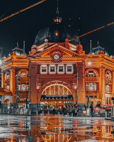 an image of a building that is lit up in the night time with lights on it